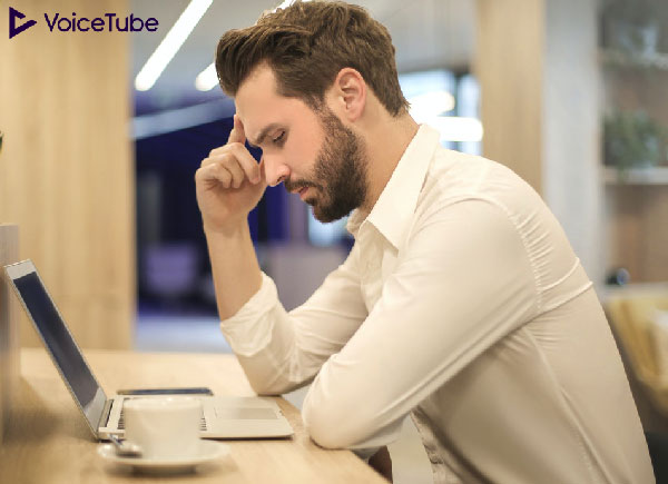 man on his computer stressed out from work